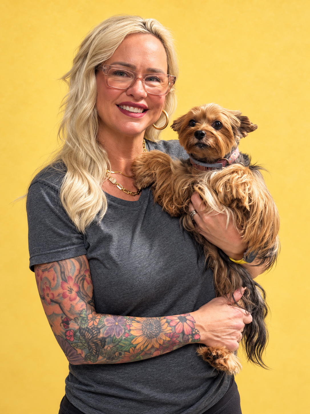 Jacqueline, owner of Groomingdales, holding a dog